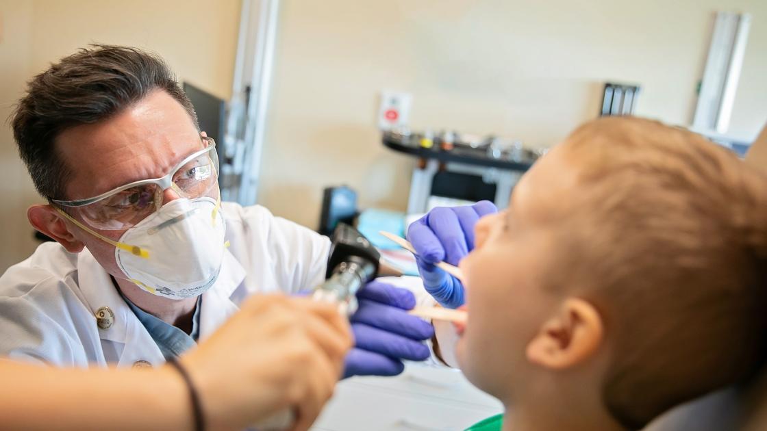 ENT doctor looks at patient photo