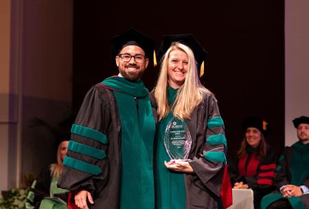 Image of Dr. Jacob Ribbing presenting Dr. Chelsea Treece with the 2023 DMSc Faculty of the Year Award