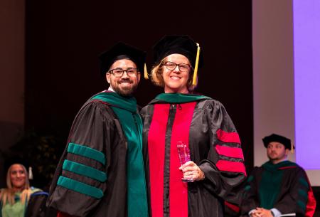 Image of Dr. Jacob Ribbing presenting Dr. Allison Terry with the Advocacy and Leadership Award